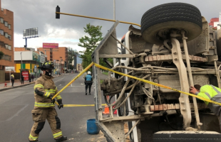 Bombero al lado de un carro volteado